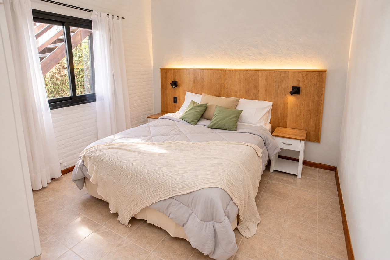 Dormitorio principal con respaldo de madera